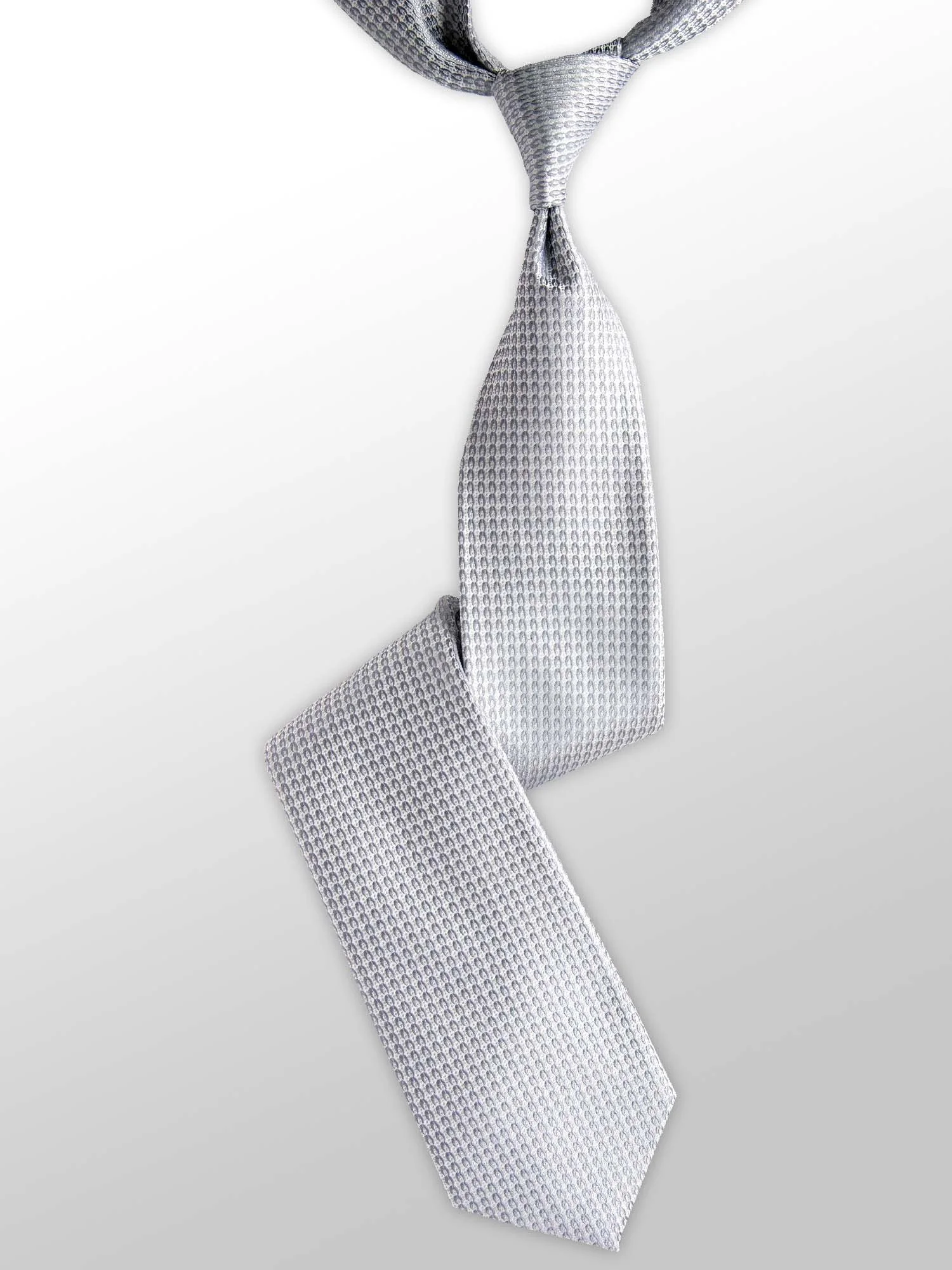 Gray patterned necktie tied in a loose knot on a white background.
