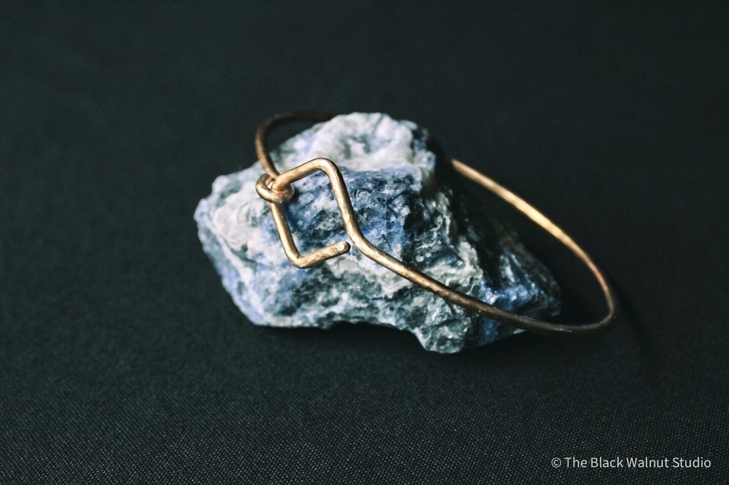The Lyria bangle in hammered brass. Sitting on my favorite piece of sodalite. :) I make these with German silver too! They go with everything. ✨⭐️