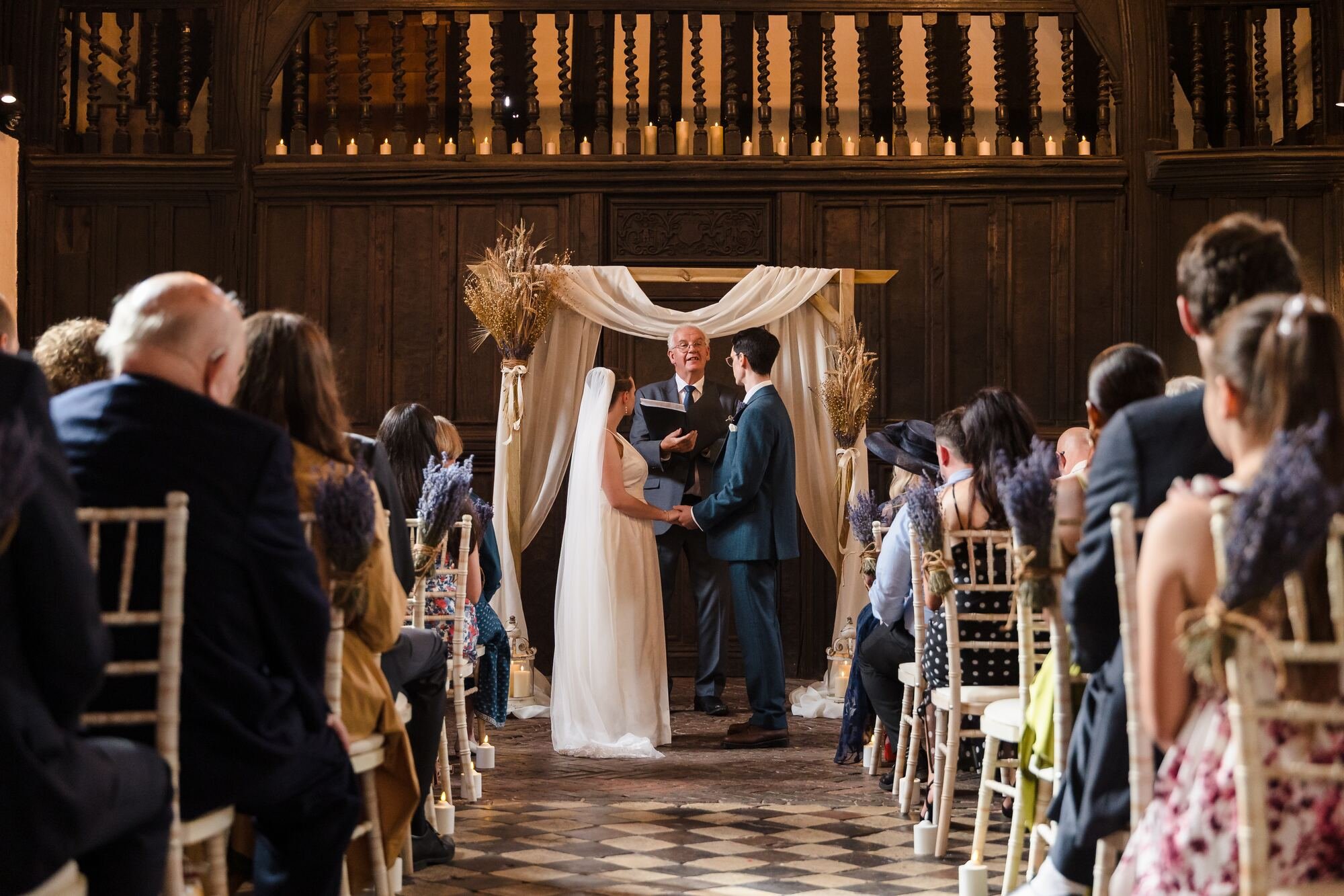 Isabelle and Chris during their civil ceremony under a draped arch in the Great Hall at The Commandery, Worcester, by Once in a Lifetime Photography
