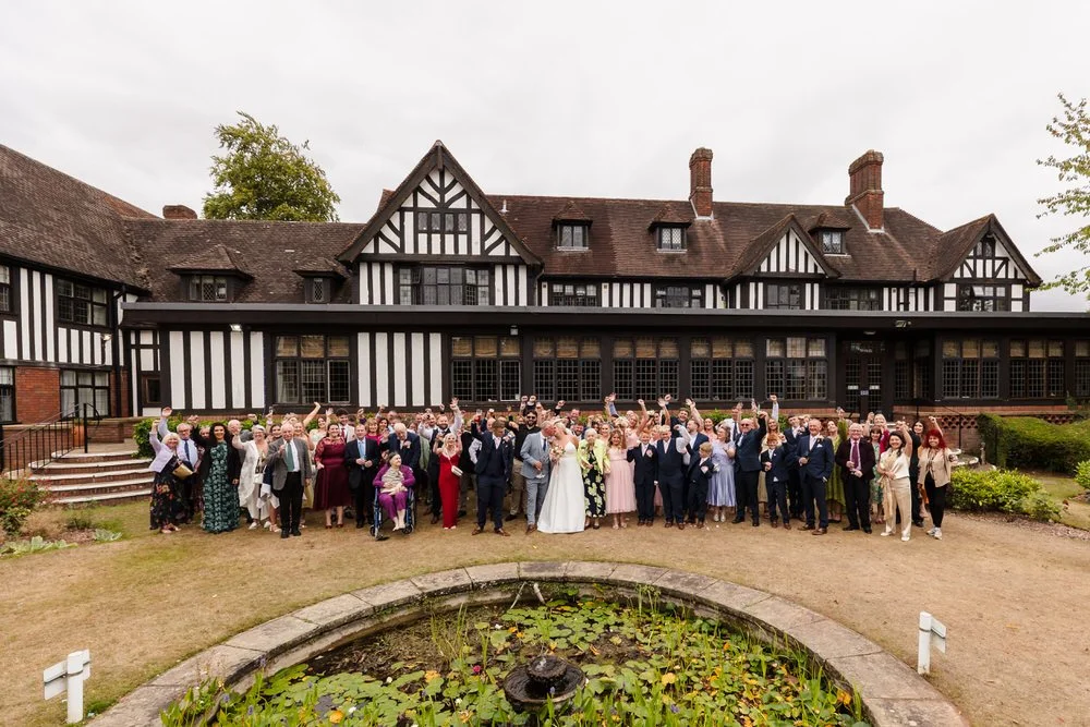 Full wedding guest group photo outside Hogarths Stone Manor Worcestershire, documentary wedding photographer