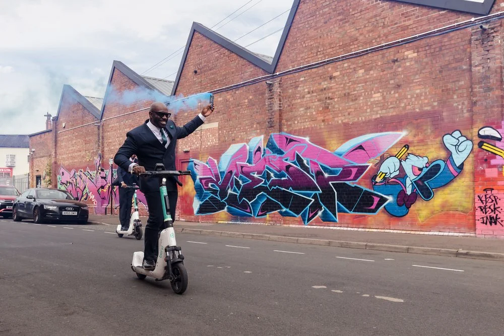 Groom on e-scooter with blue smoke bomb Digbeth Birmingham street art graffiti creative wedding photography