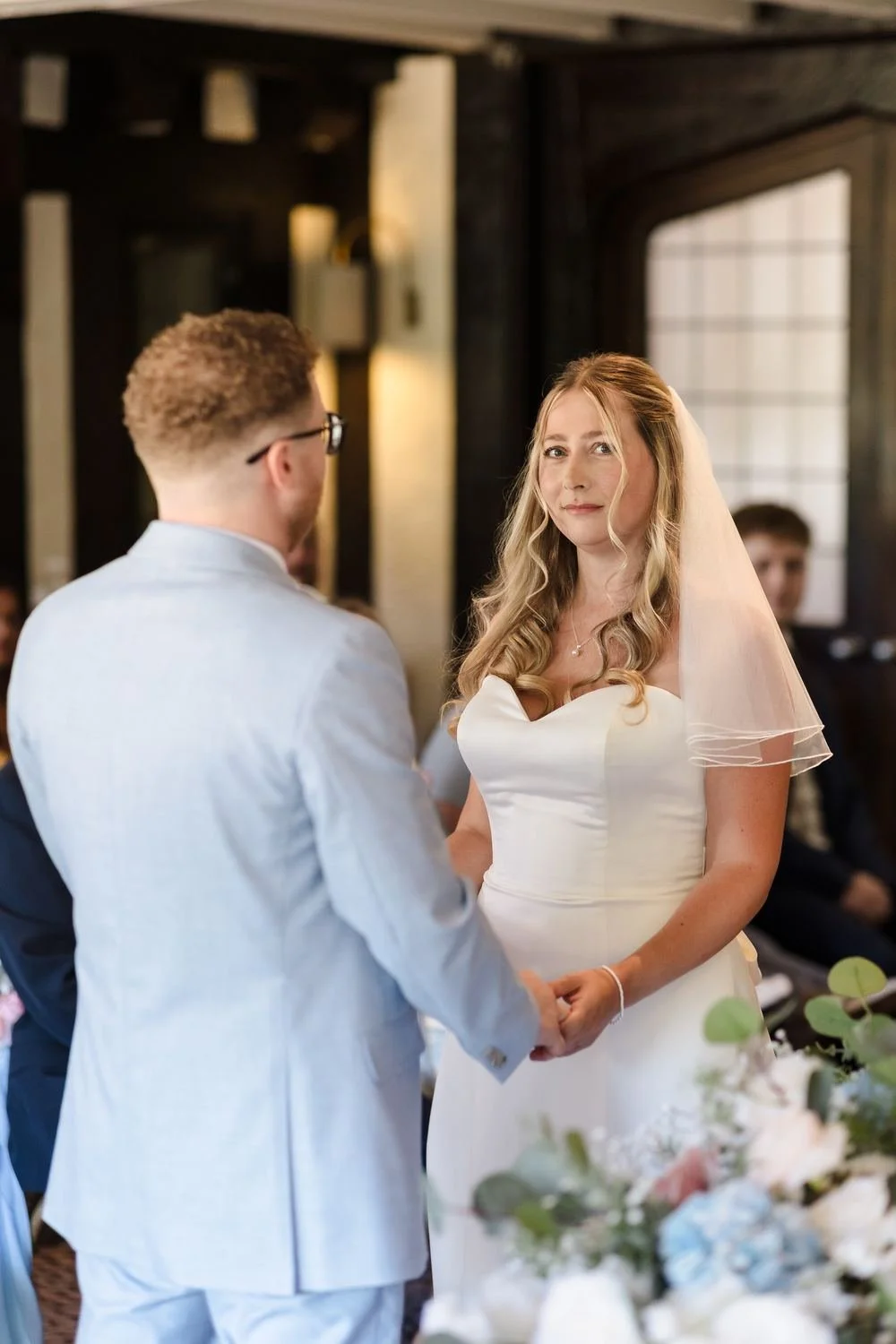 Cheryl and Josh holding hands at the front of the Drawing Room during their ceremony