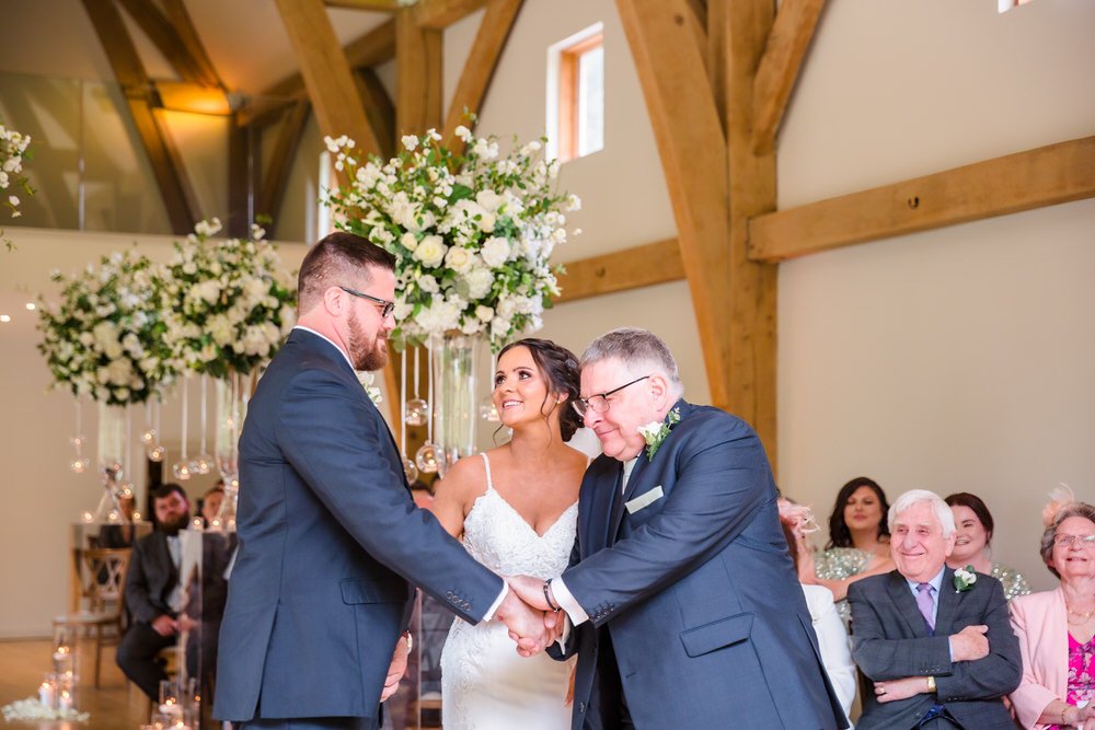 mill-barns-father-handoff-bride-groom.jpg