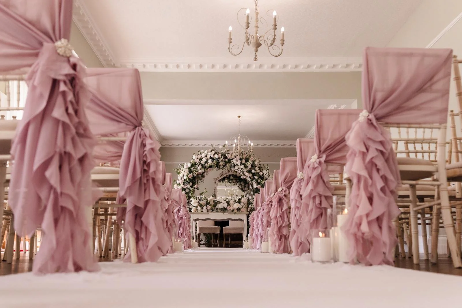 Ceremony room dressed with pink drapes and aisle florals at Ashton Lodge Country House wedding photography by Once in a Lifetime Photography