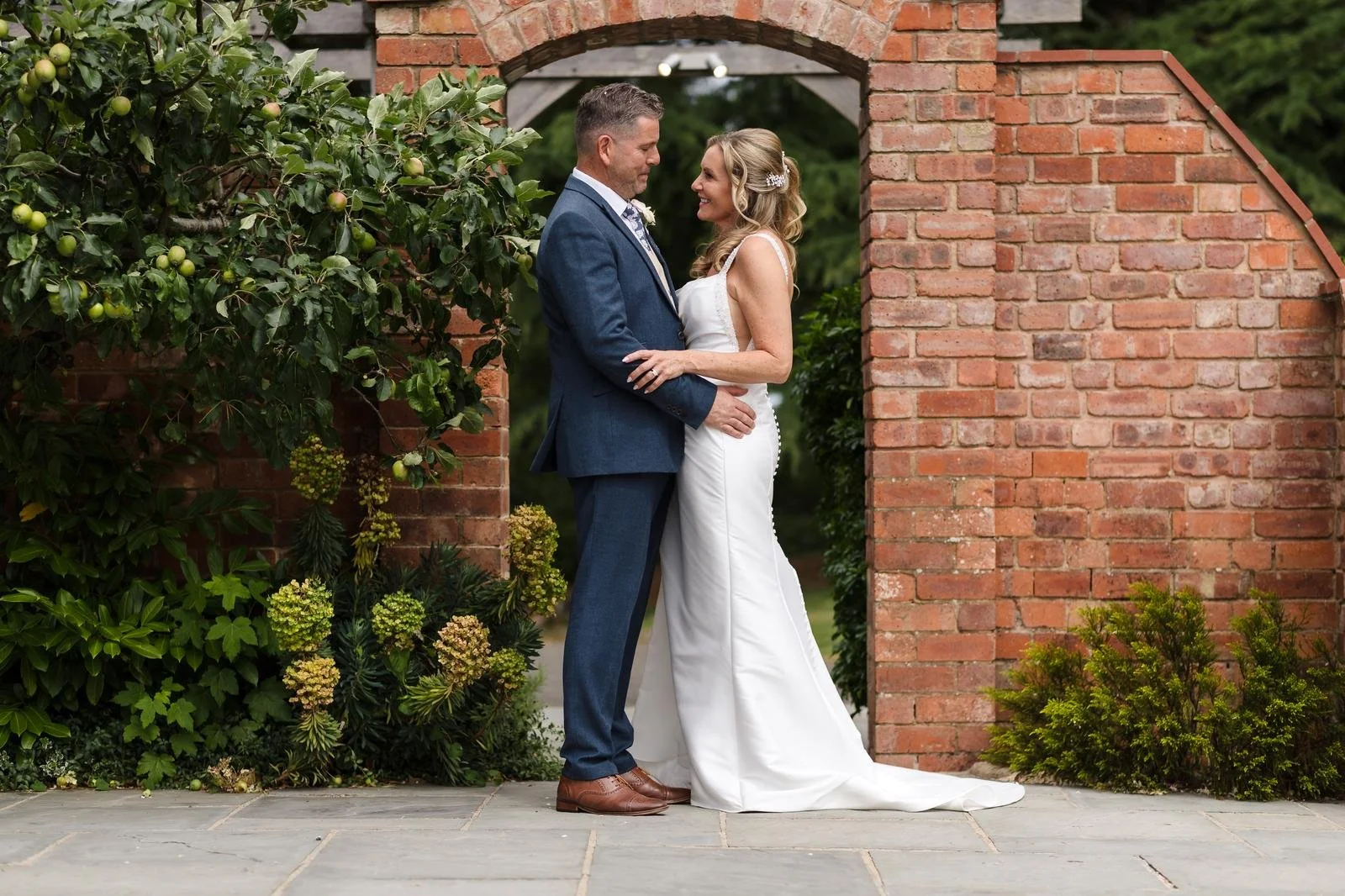 Charlotte and Richard's portrait at the brick archway at Ashton Lodge Country House wedding photography by Once in a Lifetime Photography