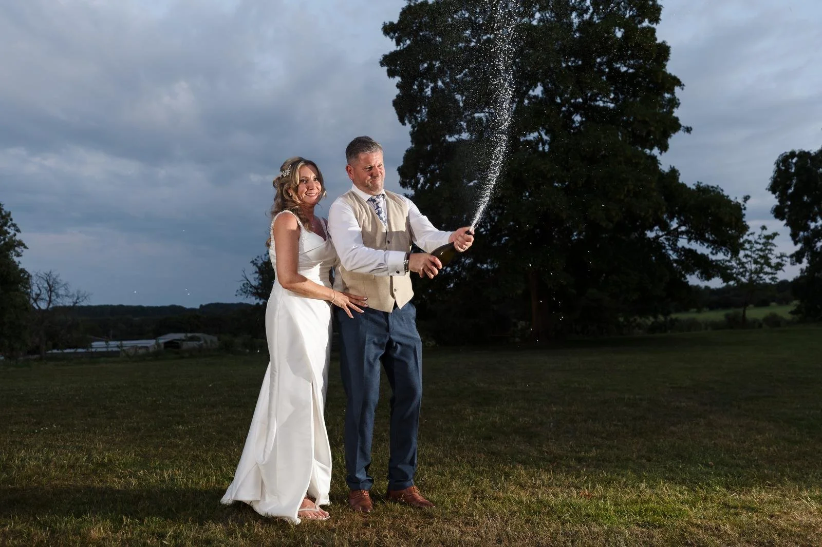 Champagne spray portrait at dusk at Ashton Lodge Country House wedding photography by Once in a Lifetime Photography