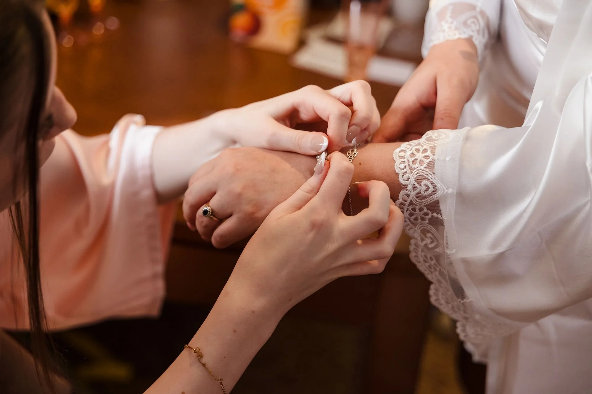 bridesmaid-fastening-bride-bracelet.jpg