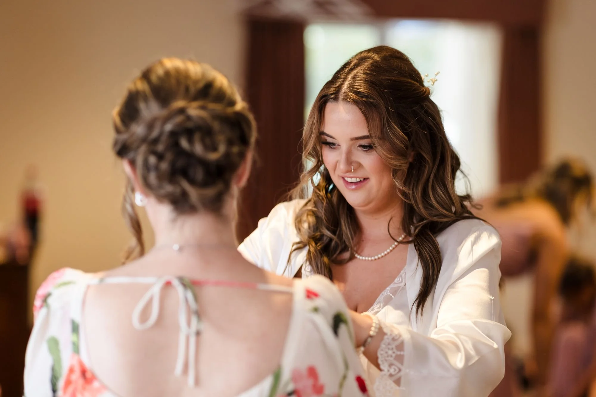 bride-holly-helping-bridesmaid-get-ready.jpg