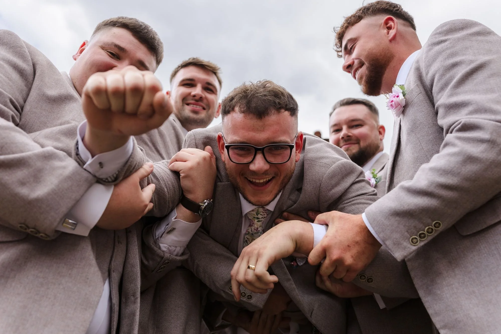 groomsmen-piling-on-groom-dan.jpg