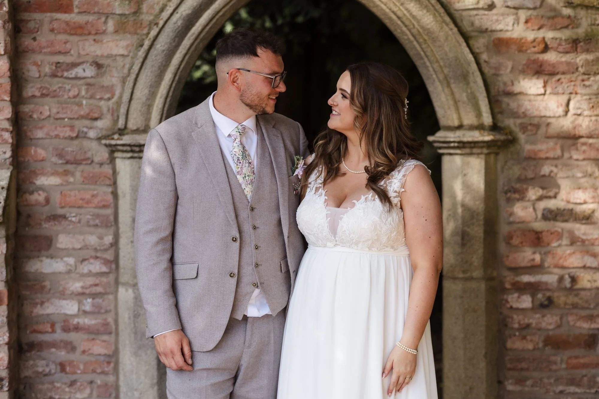 holly-and-dan-brick-archway-portrait-nailcote-hall.jpg