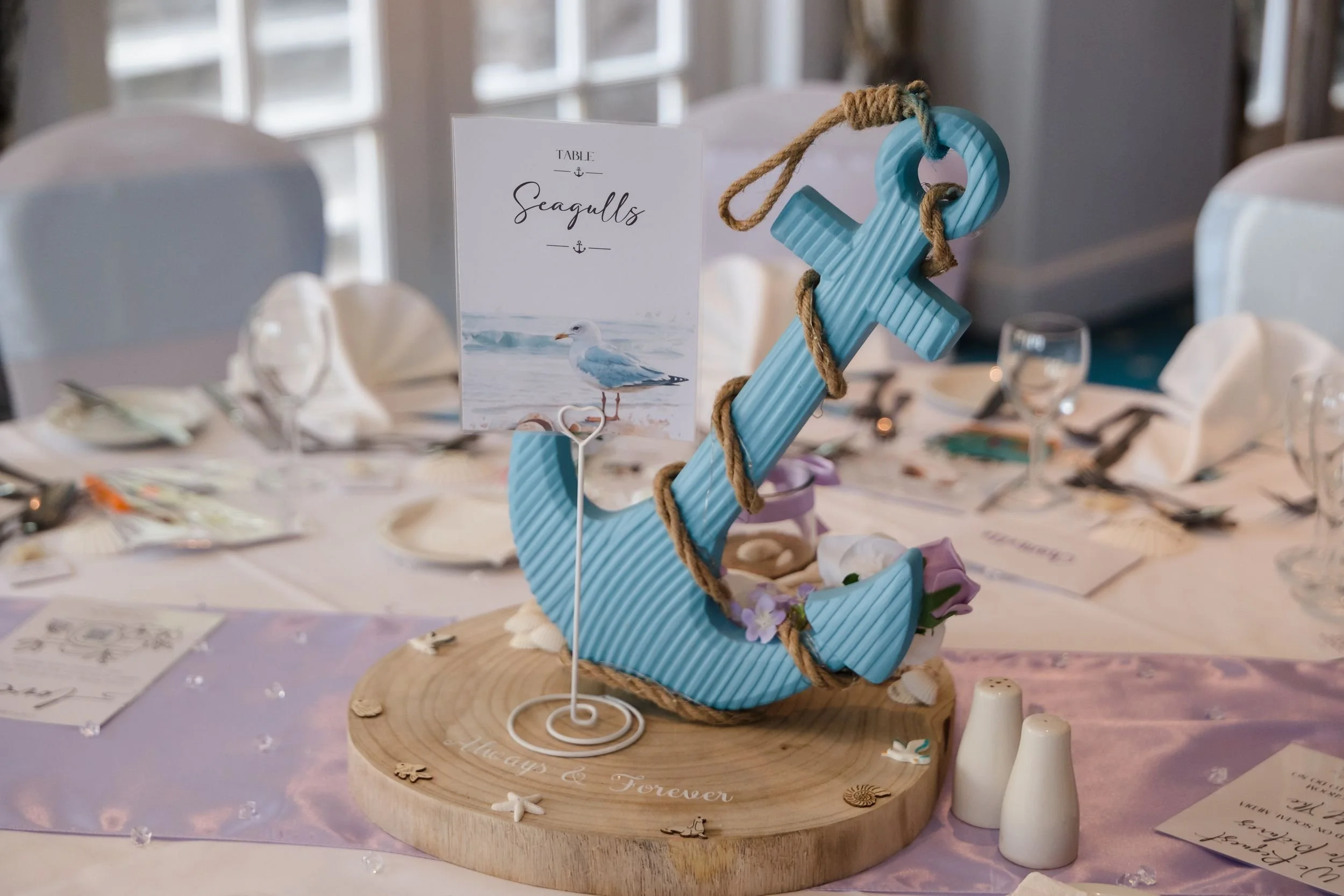 Blue anchor table centrepiece and Seagulls table name in the Mulberry Room at Berry Head Hotel