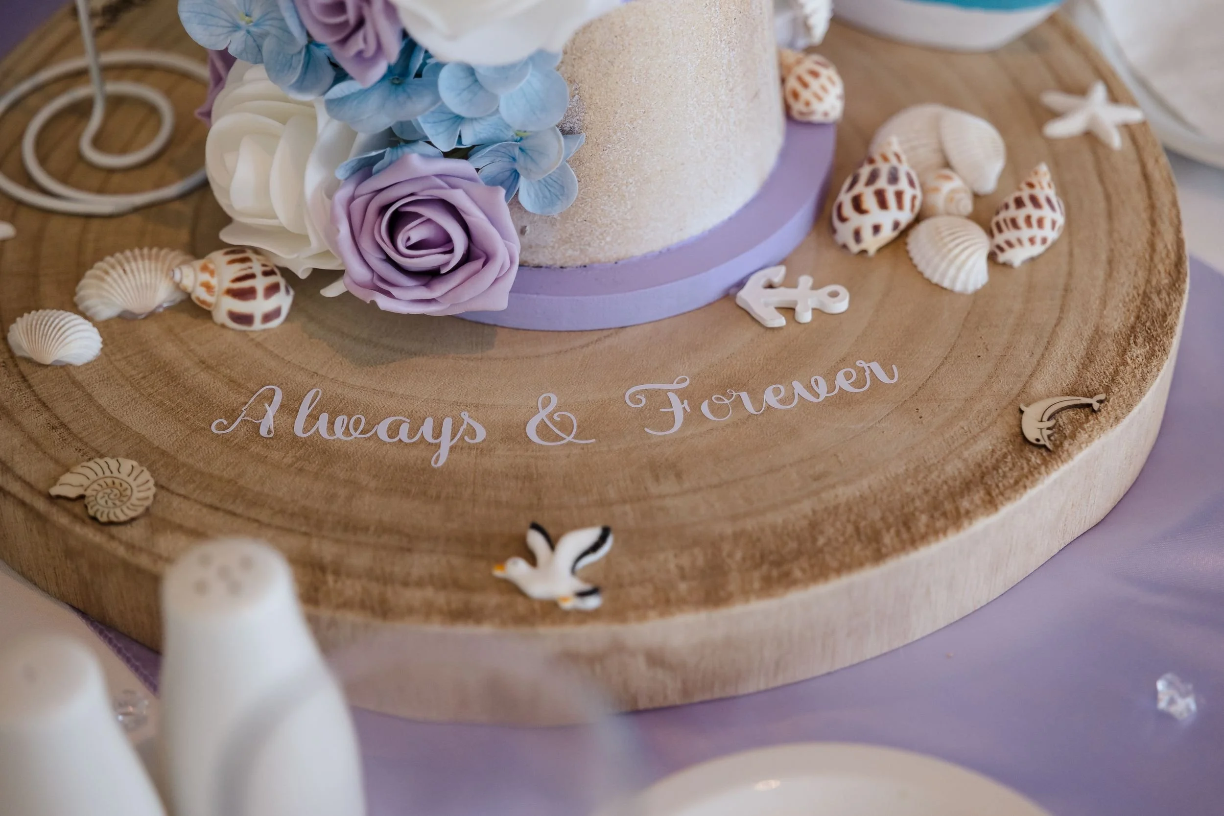 Wooden centrepiece base lettered Always and Forever, decorated with shells, an anchor and lilac roses