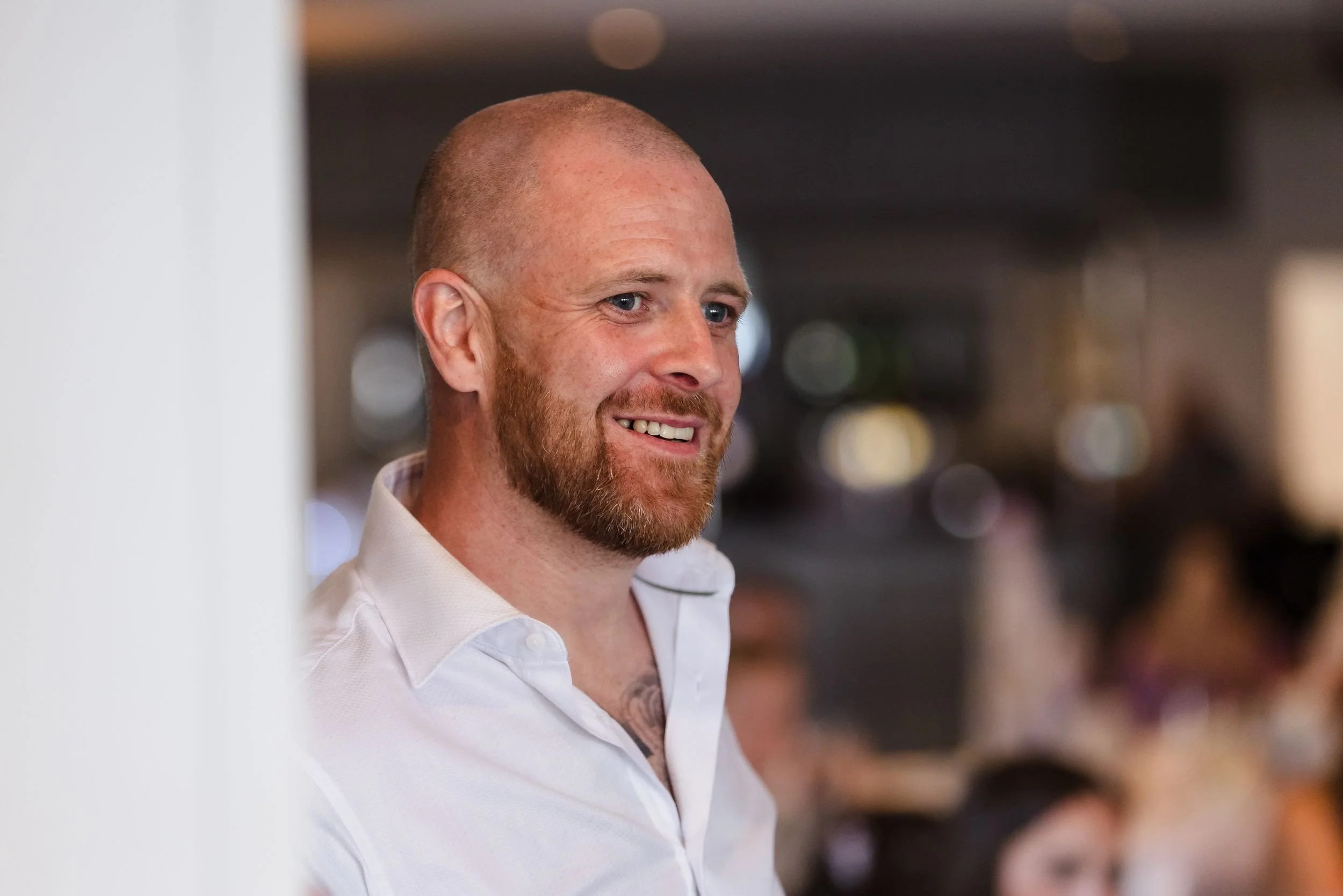 Best man smiles during the speeches at Katie and Tom's Berry Head Hotel wedding