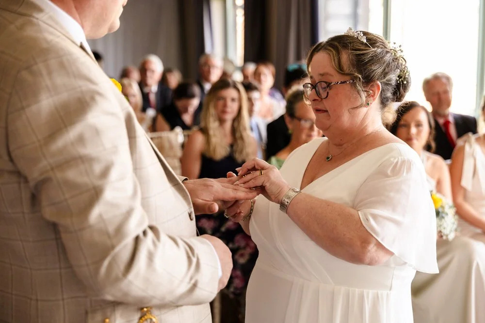 Ring exchange during a wedding ceremony at De Vere Cotswold Water Park