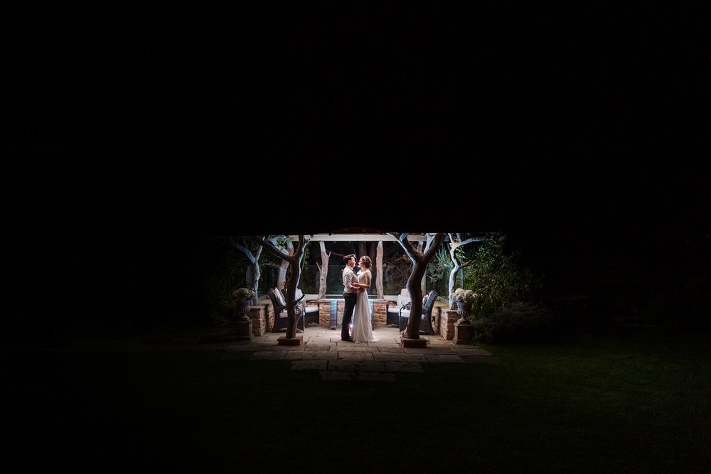bride and groom outside at night dancing