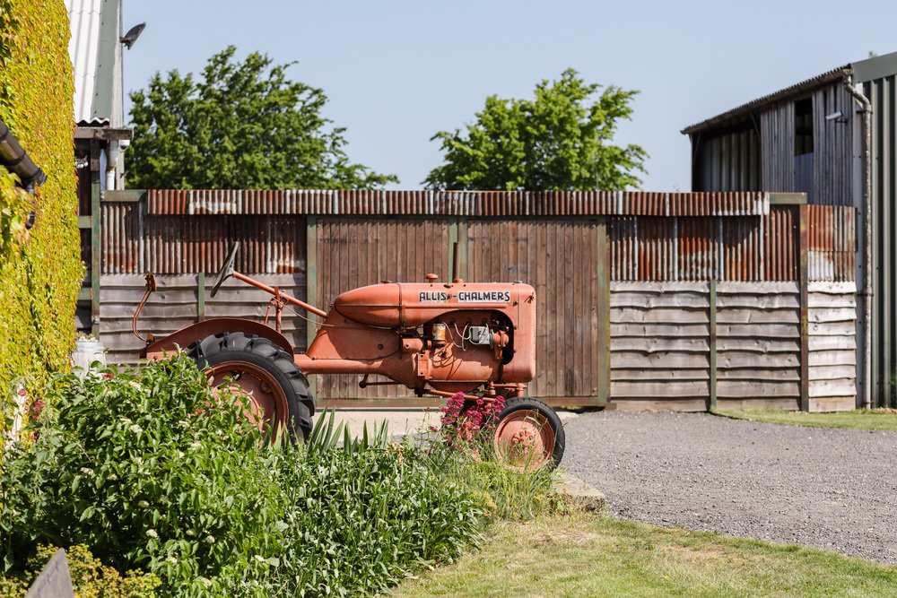 Vintage Allis-Chalmers tractor parked at Huntsmill Farm, a popular wedding photo spot.