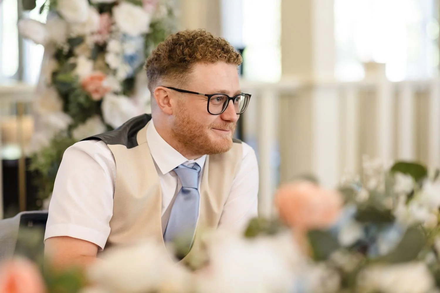 Josh smiling as he listens to the speeches in the Garden Room