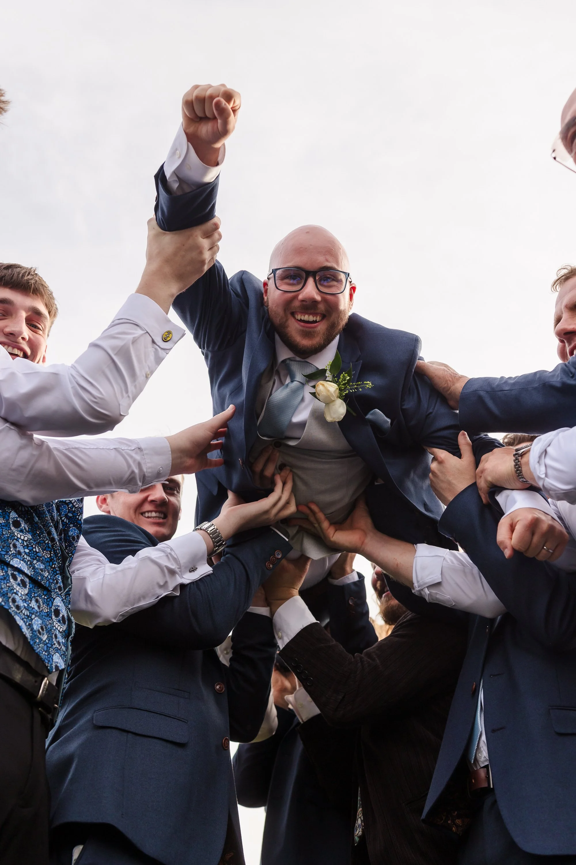 Groomsmen lifting the groom in celebration, candid reception moment captured at a Worcestershire wedding