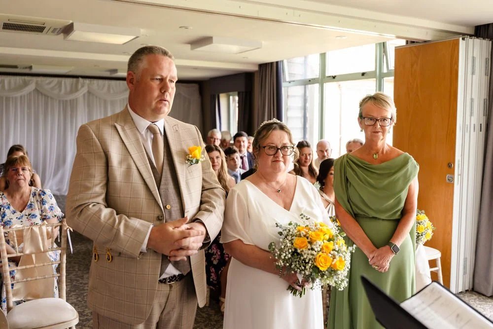 Bride and groom standing together during their ceremony at De Vere Cotswold Water Park
