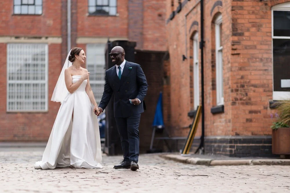 Bride and groom candid portrait The Bond Birmingham industrial courtyard documentary wedding photography