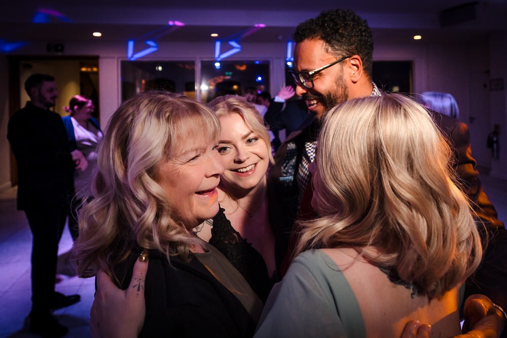Family and wedding guests celebrating together at Arley House reception, candid documentary photography by Once in a Lifetime Photography