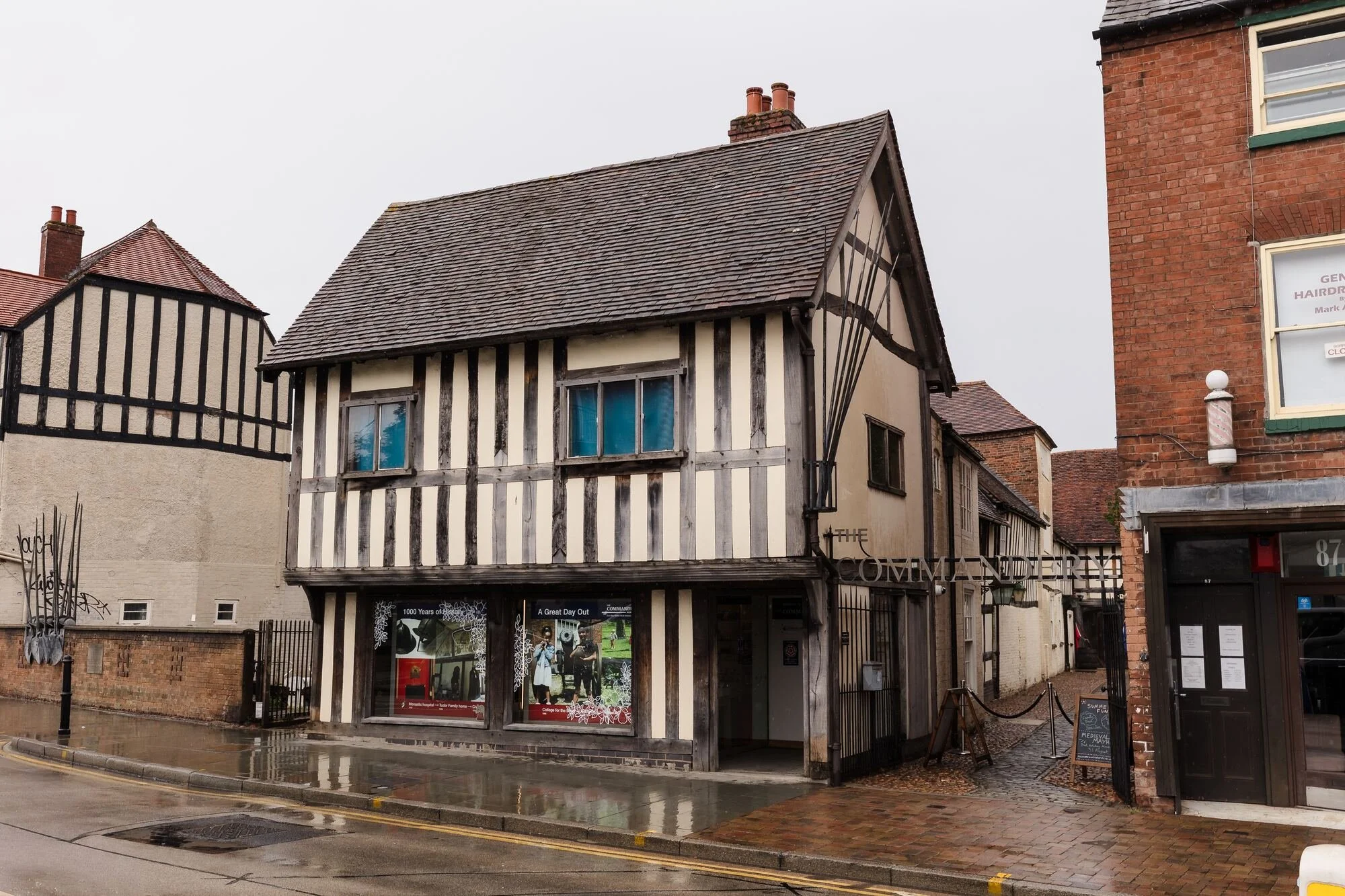 Timber-framed Tudor frontage of The Commandery on Sidbury, Worcester, on a rainy wedding day, by Once in a Lifetime Photography