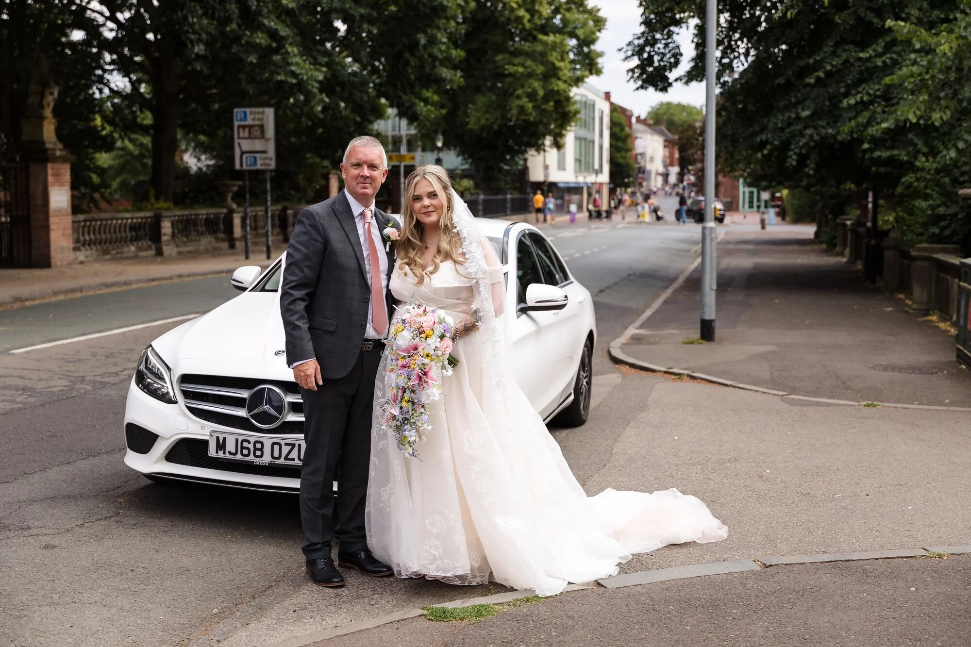 The bride and her father on Bird Street outside Lichfield Registry Office, wedding photography by Once in a Lifetime Photography.