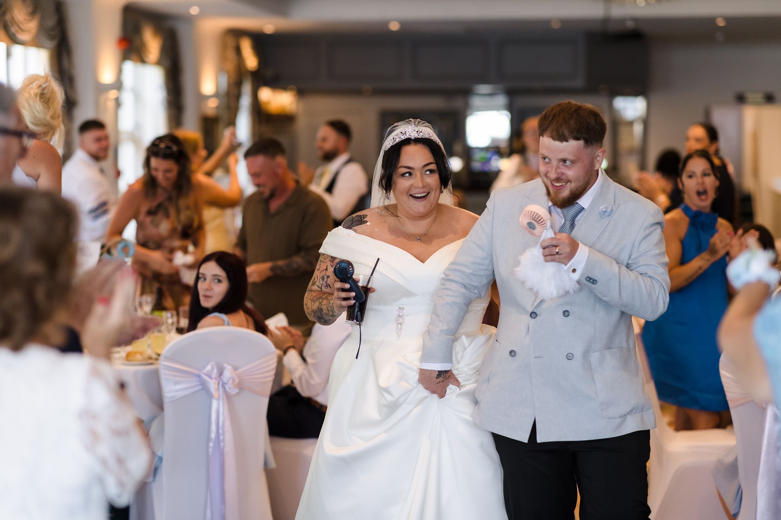 Bride and groom make their entrance to the wedding breakfast in the Mulberry Room at Berry Head Hotel
