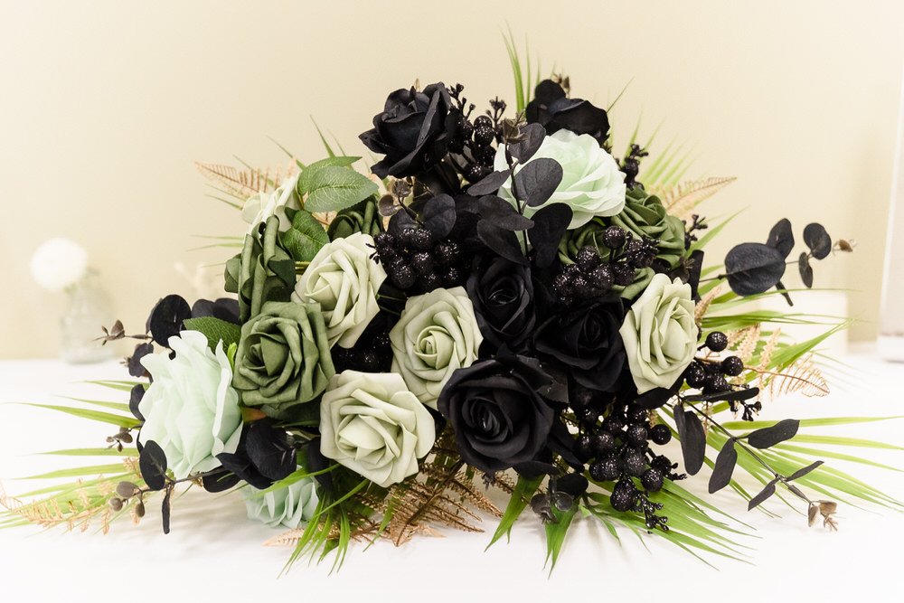 Gothic wedding bouquet with black and sage green roses, dramatic floral photography by Once in a Lifetime Photography
