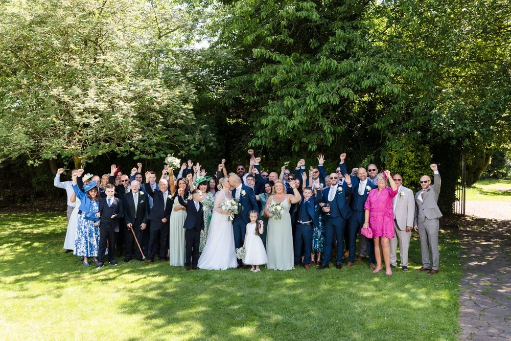 Wedding party group photograph in the walled garden at Hogarths Stone Manor