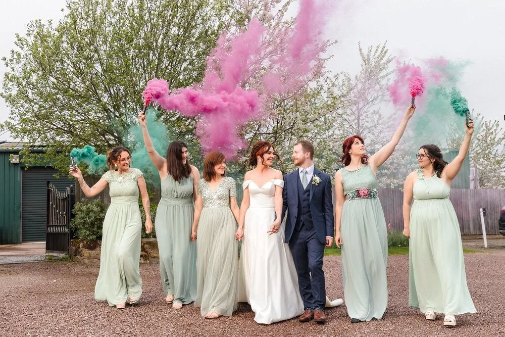 tidal party walking with smoke bombs at wedding
