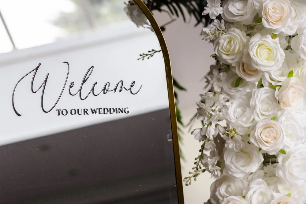 Welcome to our wedding sign with white rose floral arrangement at The Limes Country Lodge — wedding detail photography by Paul Hickey, Once in a Lifetime Photography