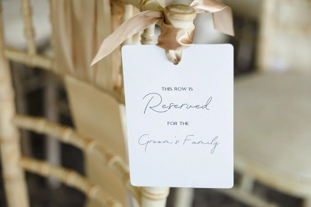 Reserved seating sign tied with ribbon at a De Vere Cotswold Water Park wedding ceremony