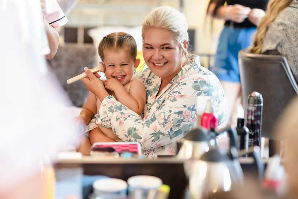 Bride with flower girl during bridal preparations at Hogarths Stone Manor, candid wedding photography