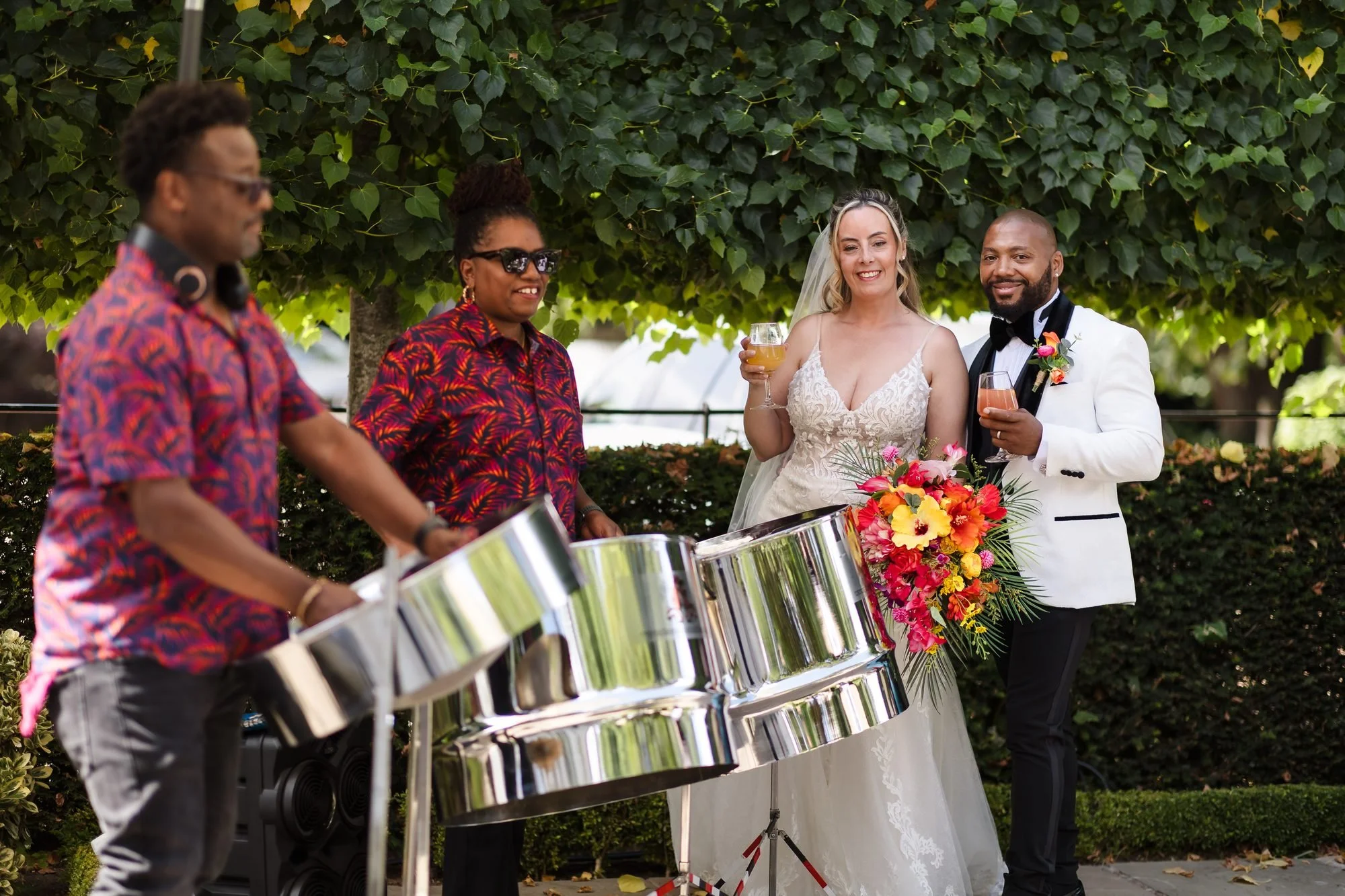 Phase One Steel Band playing steel pans for the bride and groom during the drinks reception at Warwick House