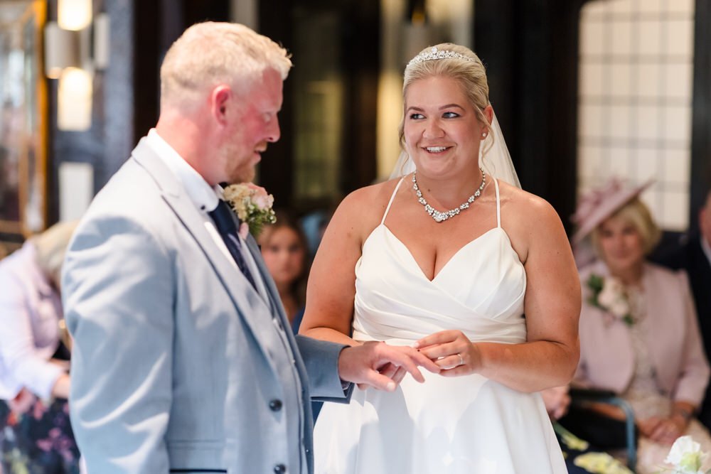 Jess and Brian exchanging rings during Hogarths Stone Manor wedding ceremony, documentary wedding photography