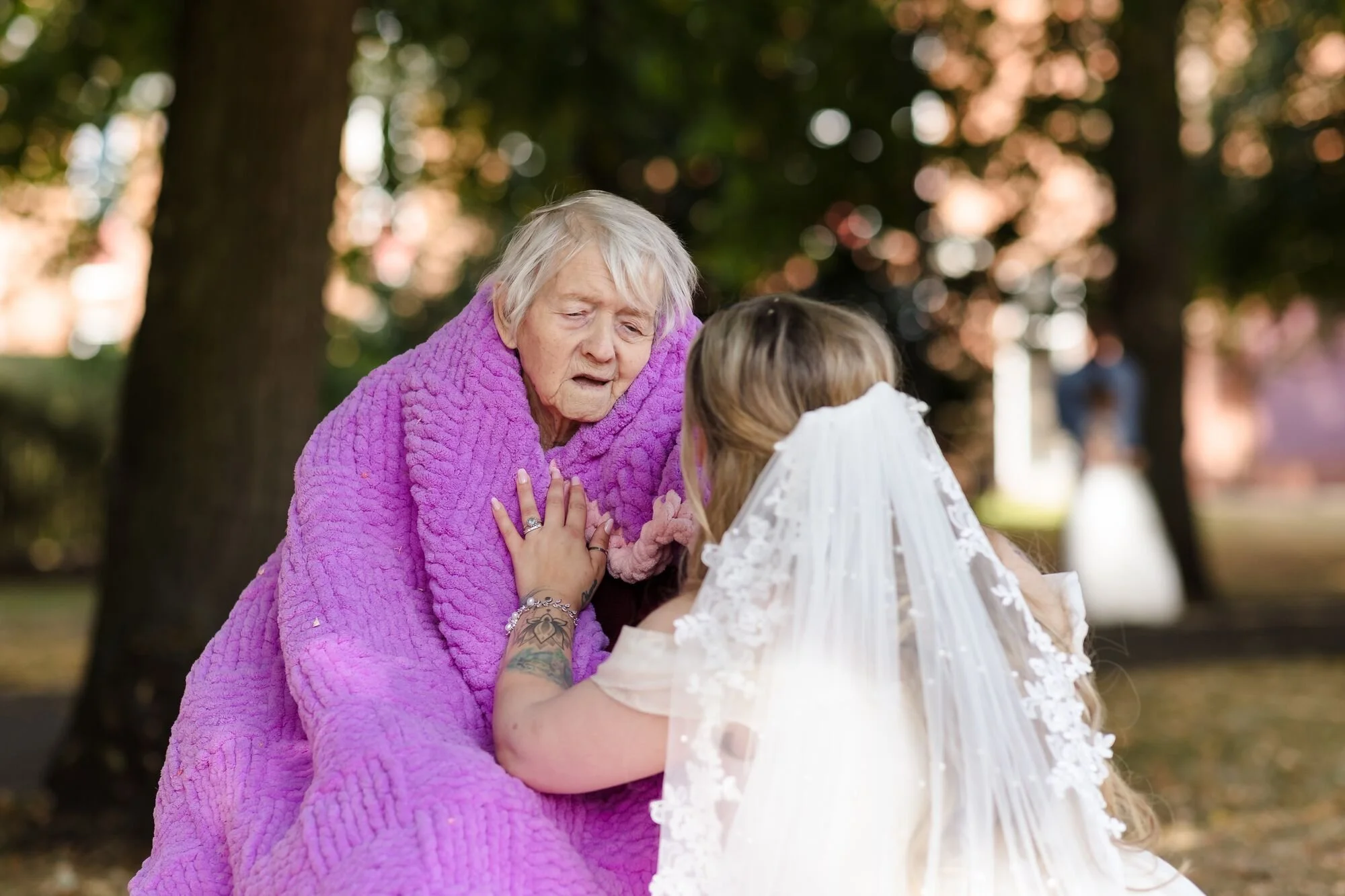 A quiet moment between the bride and her grandmother in Museum Gardens, Lichfield, wedding photography by Once in a Lifetime Photography.