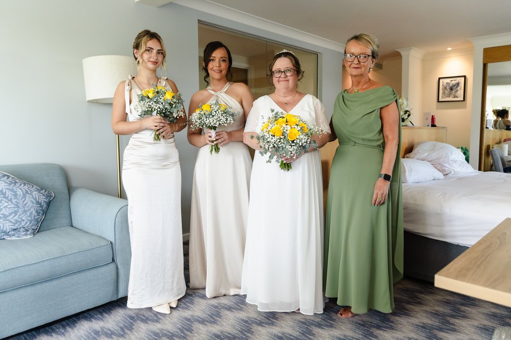 Bride and bridal party with yellow bouquets getting ready at De Vere Cotswold Water Park