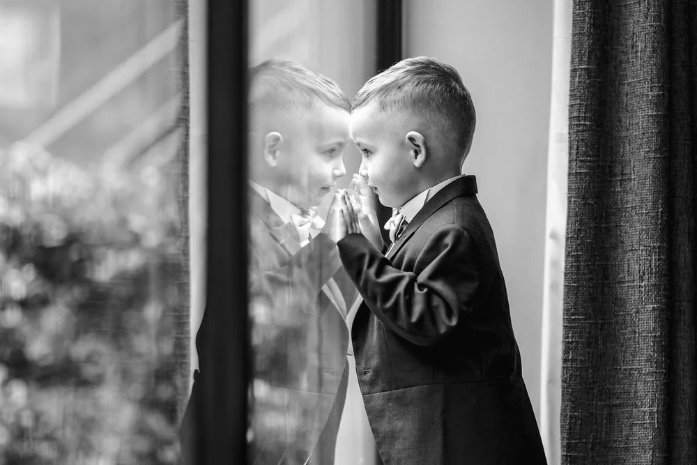 young guest at a wedding staring out of the window