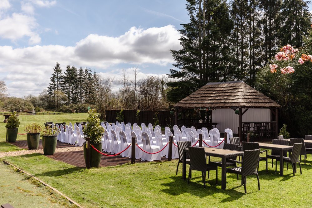Wide garden view at The Limes Solihull showing outdoor ceremony setup and thatched gazebo — documentary wedding photography by Paul Hickey