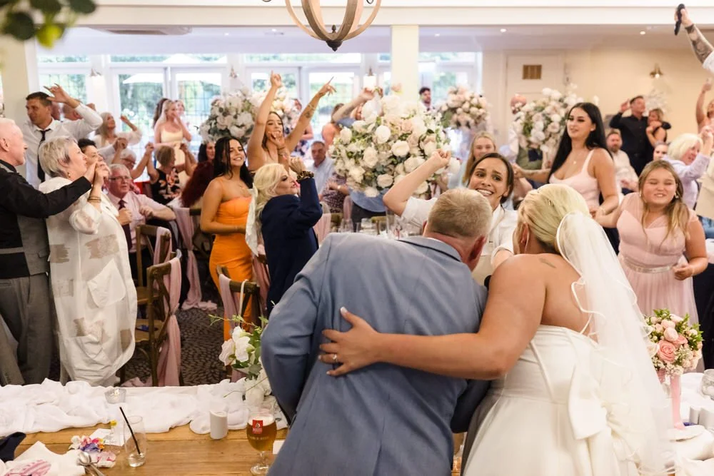Guests cheering during wedding reception at Hogarths Stone Manor, documentary wedding photography Worcestershire