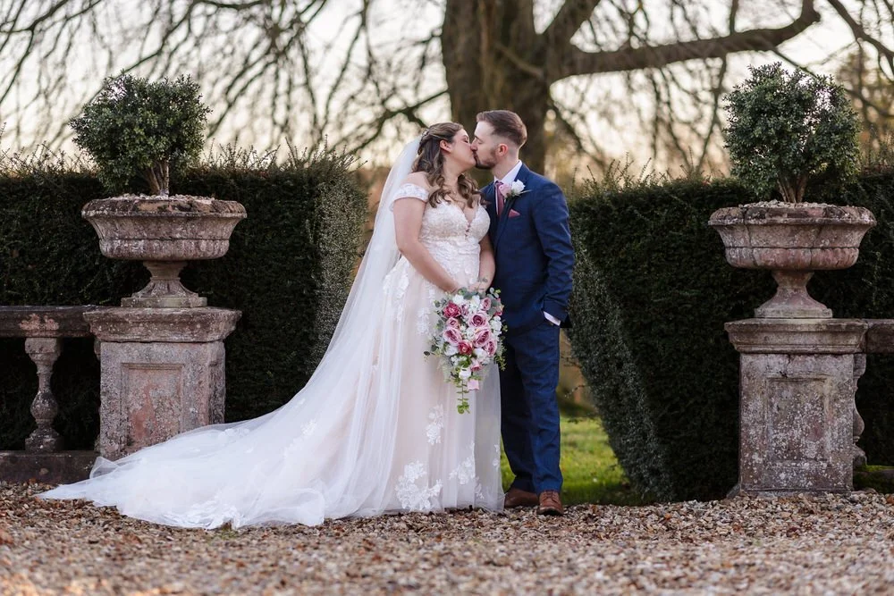 Bride and groom portrait in formal gardens at Bredenbury Court Barns