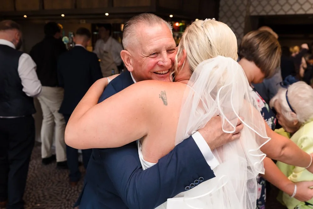 Emotional moment between bride and father at Hogarths Stone Manor wedding reception, candid wedding photography