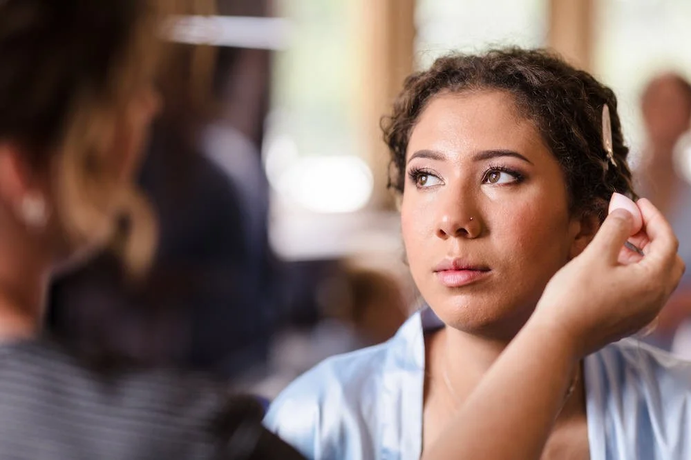Bridal makeup finishing touches during morning preparations at Karma Salford Hall, natural light portrait.