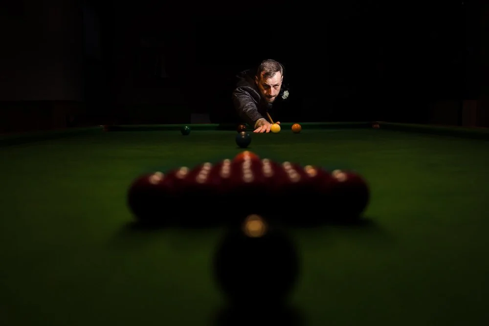 Dramatic groom portrait playing snooker with creative lighting at Arley House wedding reception, signature evening photography by Once in a Lifetime Photography Worcestershire