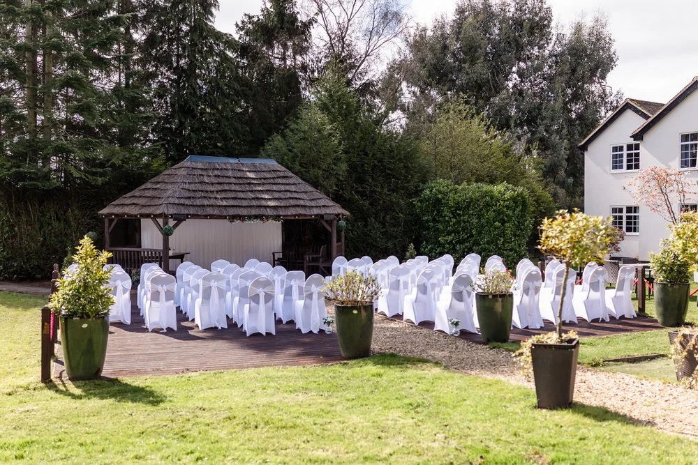 Outdoor wedding ceremony setup at The Limes Country Lodge thatched gazebo, Earlswood — wedding photography by Paul Hickey, Worcestershire