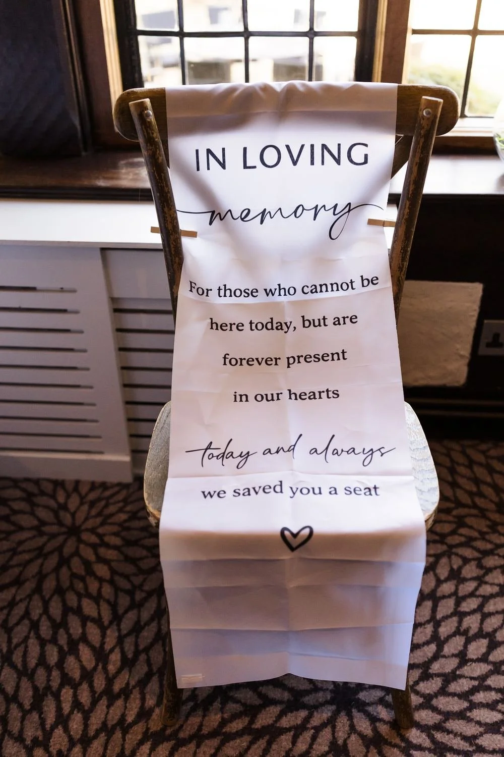 Memorial chair in the Drawing Room with an In Loving Memory sign reading we saved you a seat
