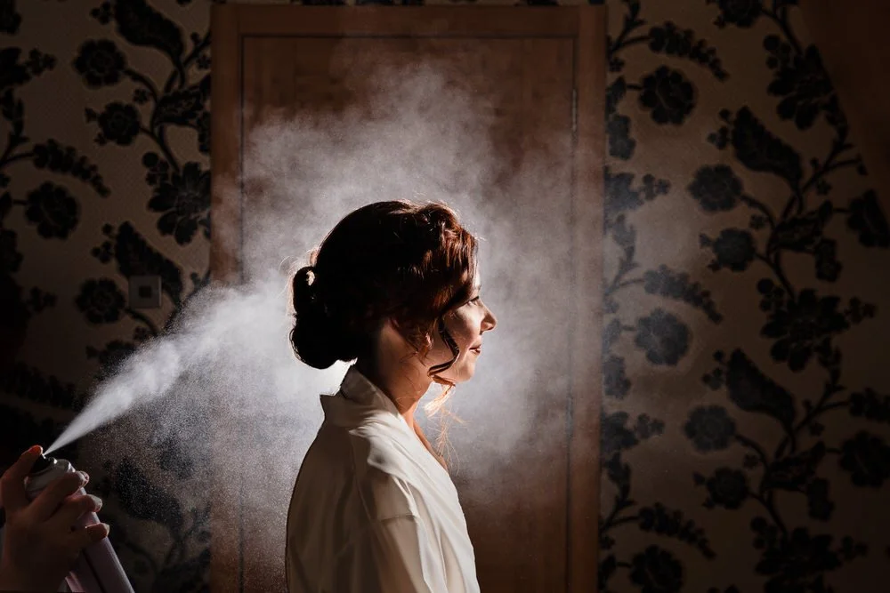 bride having her hair sprayed