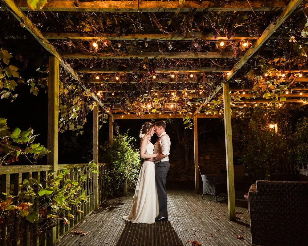 bride and groom backlit outside at night
