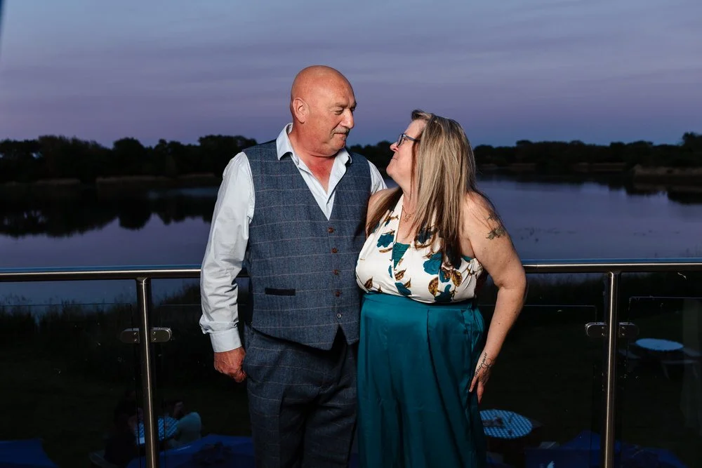 Creative evening couple portrait on the balcony at dusk at De Vere Cotswold Water Park